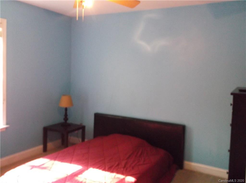 12450 Banks Road Mount Pleasant, NC 28124 - Photo 25 of 43 a bedroom with a bed and a lamp on dresser