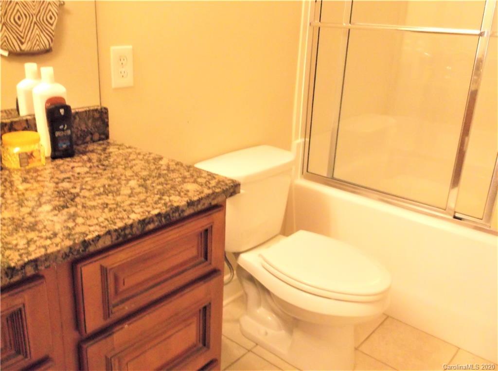 12450 Banks Road Mount Pleasant, NC 28124 - Photo 29 of 43 a bathroom with a granite countertop sink and a toilet