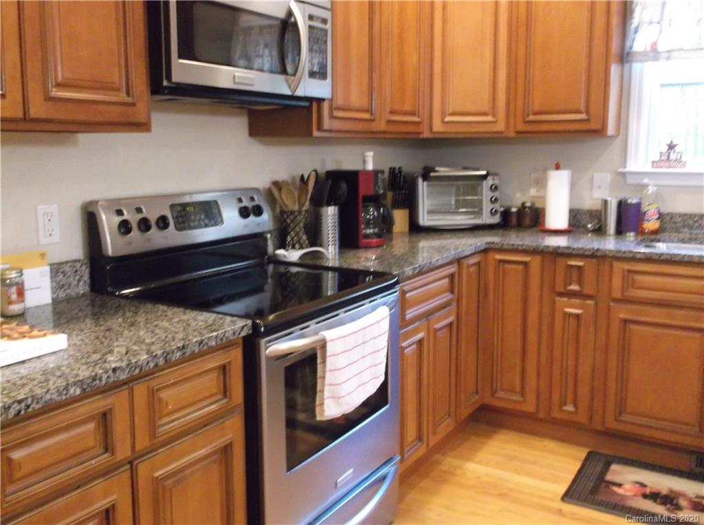 12450 Banks Road Mount Pleasant, NC 28124 - Photo 9 of 43 a kitchen with stainless steel appliances granite countertop a sink stove and cabinets