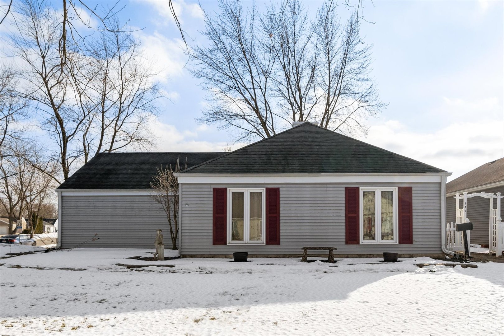 135 Heathgate Road Montgomery, IL 60538 - Photo 1 of 17 a front view of a house with yard and trees in the background