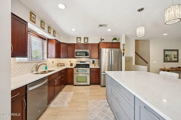 a large white kitchen with a large window