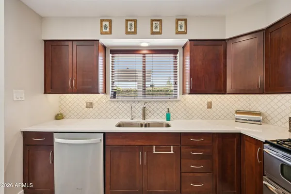 a kitchen with a sink and a refrigerator