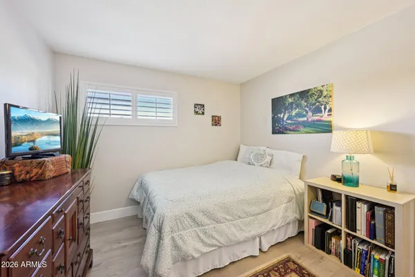 a bedroom with a large bed a chandelier and closet