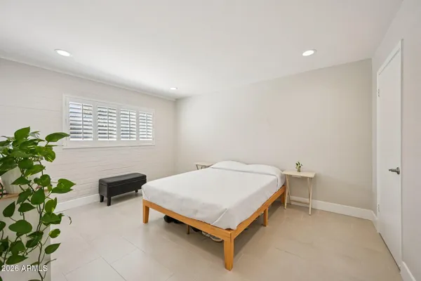 a bedroom with a bed and a dresser in it