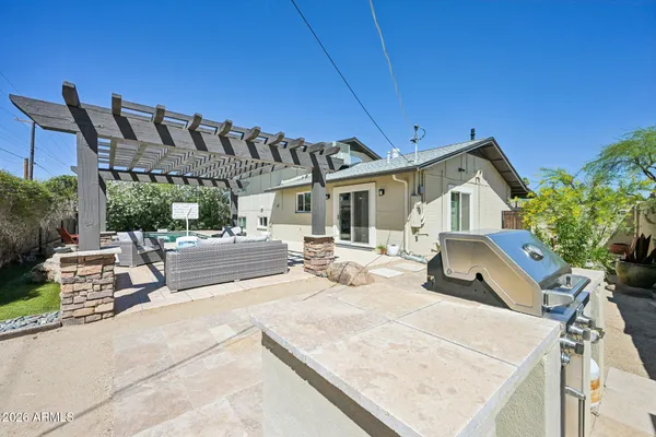 a view of a patio with couches chairs and wooden floor