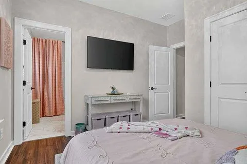 a bedroom with a bed and a flat screen tv