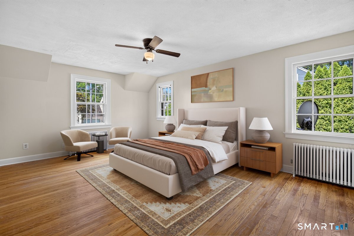 58 Myra Road Hamden, CT 06517 - Photo 17 of 40 a spacious bedroom with a bed and wooden floor