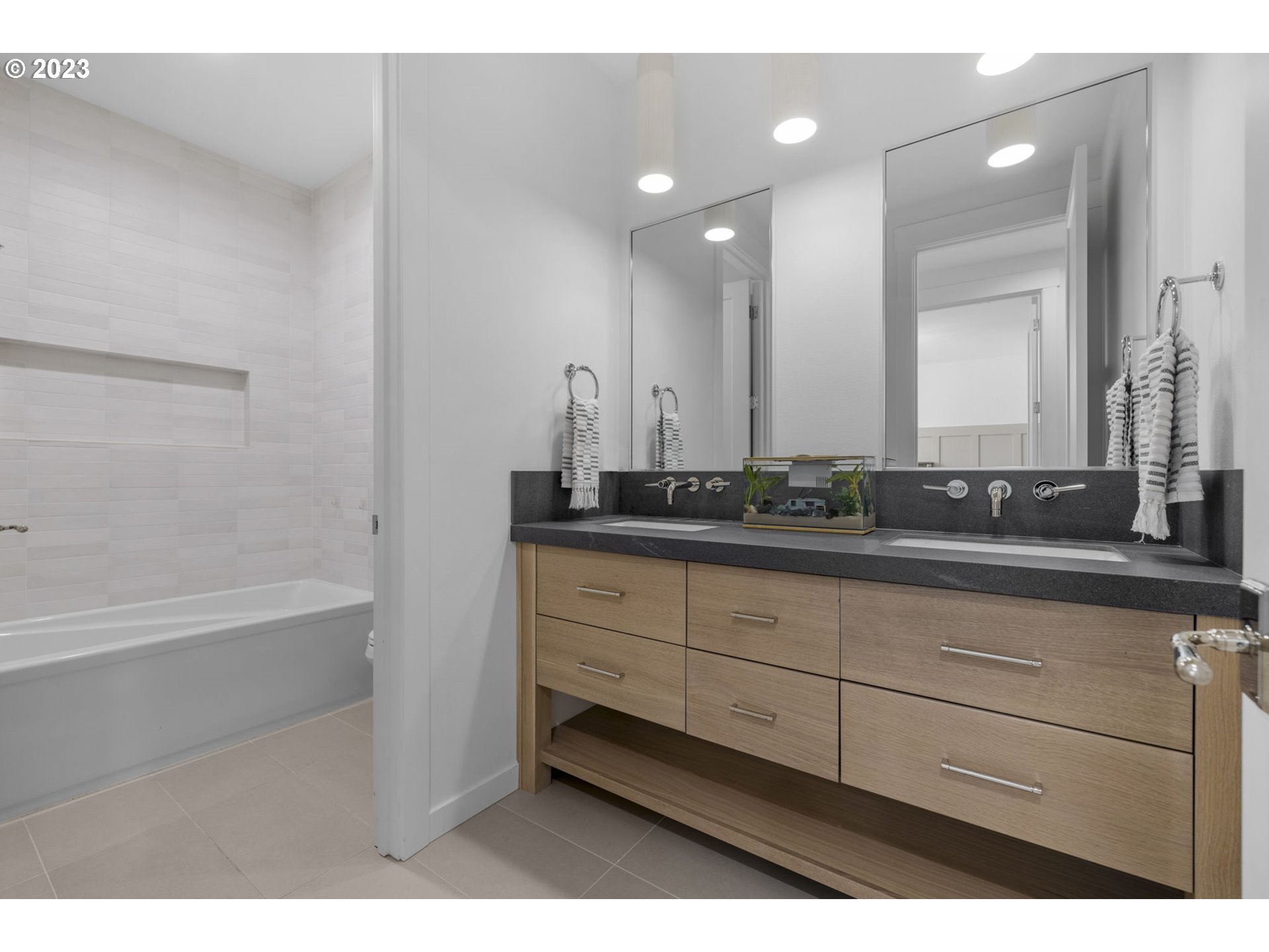 3410 Northwest McMaster Drive Camas, WA 98607 - Photo 29 of 43 a bathroom with a sink a mirror and a bathtub