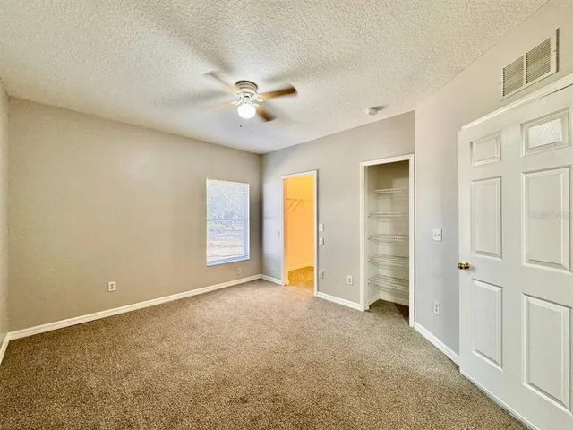 a view of empty room with ceiling fan