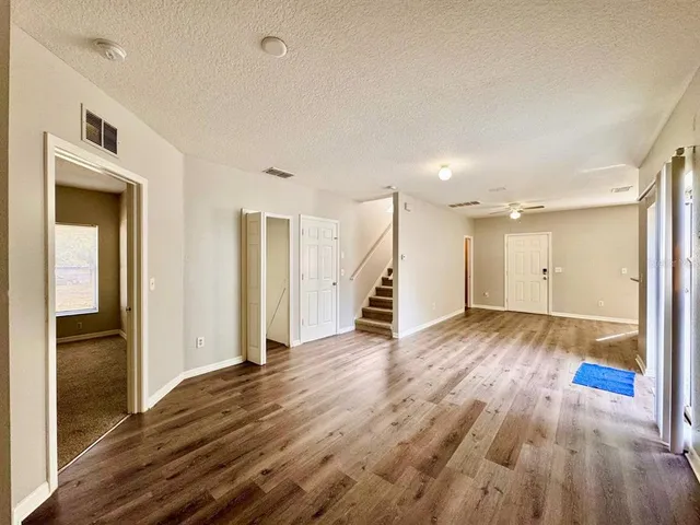 a view of a hallway with wooden floor