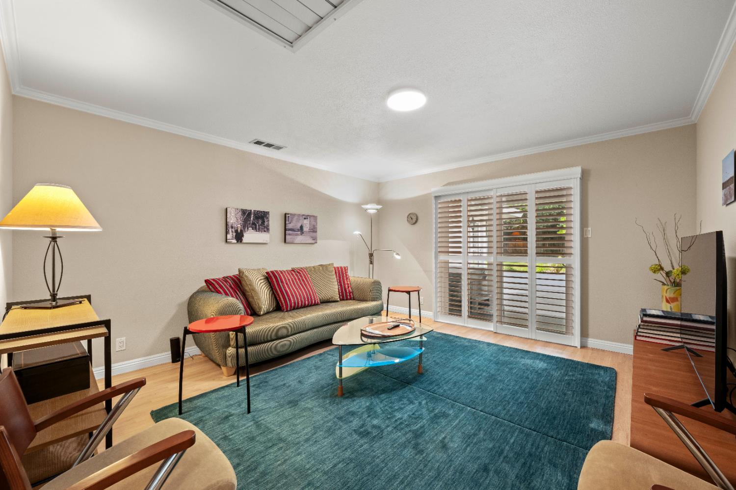 1325 Philomene Court Carmichael, CA 95608 - Photo 16 of 40 a living room with furniture a flat screen tv and a window