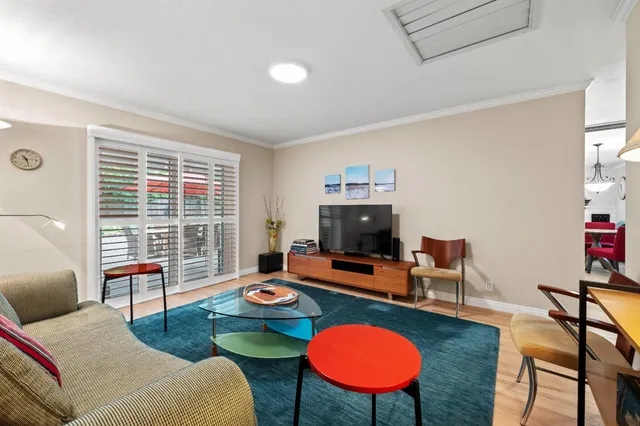 a living room with furniture a rug and a window