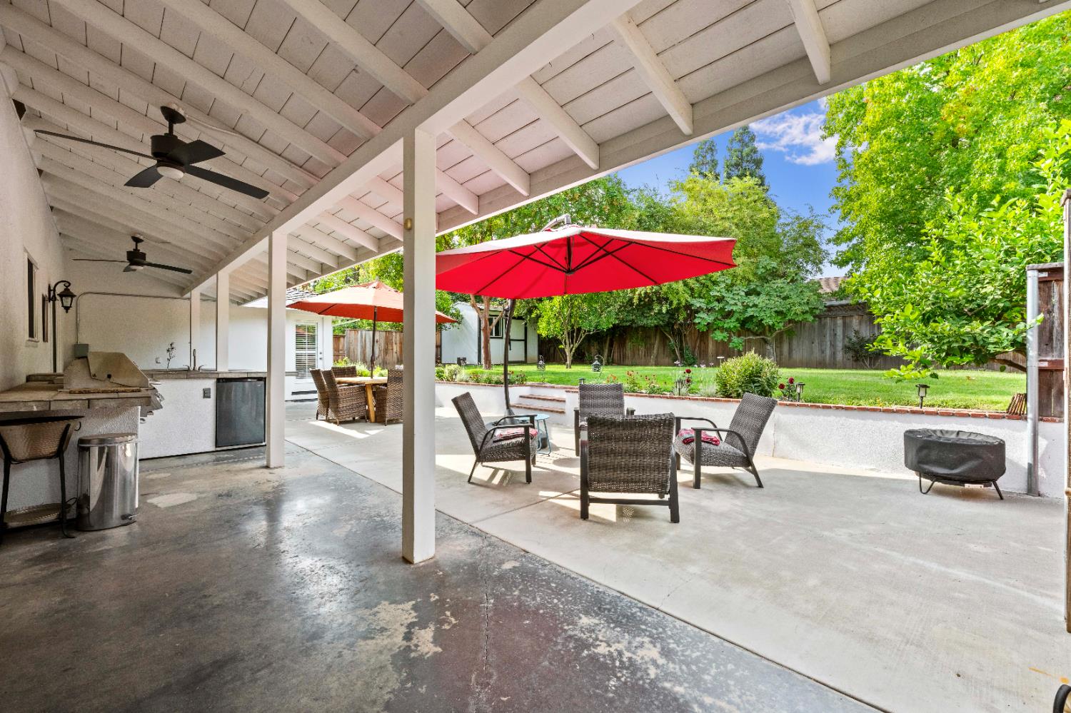 1325 Philomene Court Carmichael, CA 95608 - Photo 28 of 40 a view of a patio with table and chairs under an umbrella