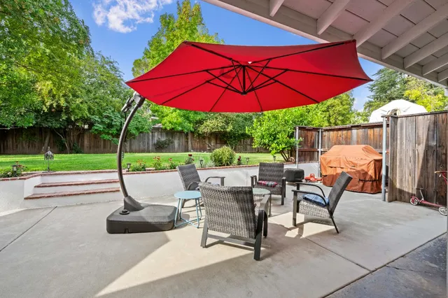 a view of a table and chairs under an umbrella