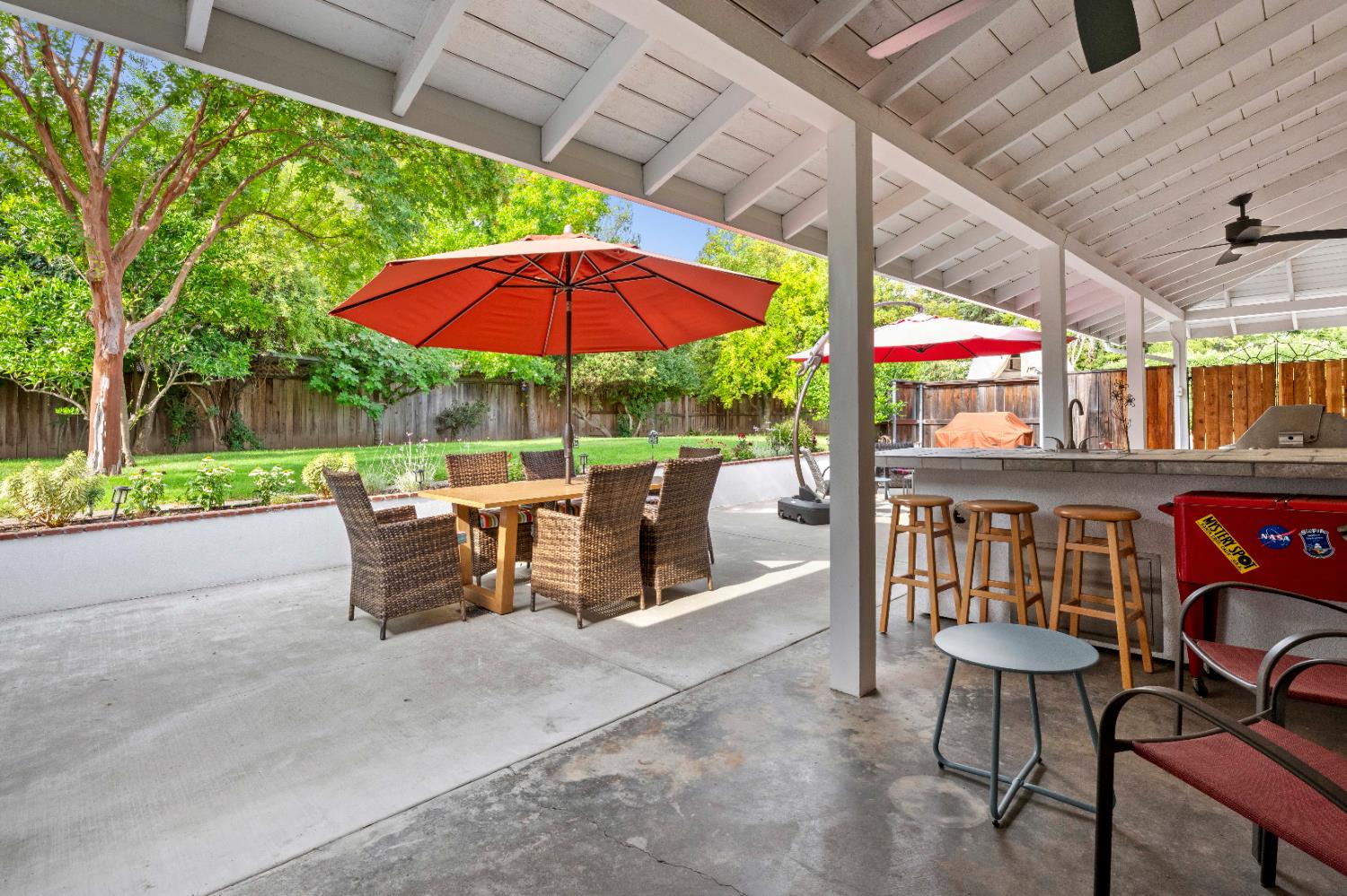 1325 Philomene Court Carmichael, CA 95608 - Photo 31 of 40 a view of a patio with a table and chairs under an umbrella