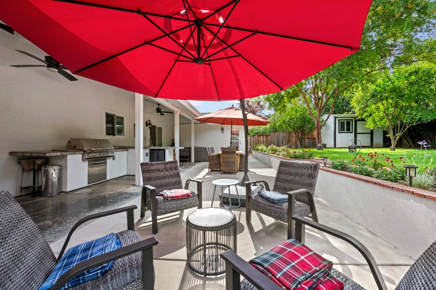 1325 Philomene Court Carmichael, CA 95608 - Photo 32 of 40 a view of a patio with chairs and table under an umbrella
