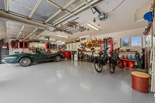 a view of parking garage with cars and other equipment