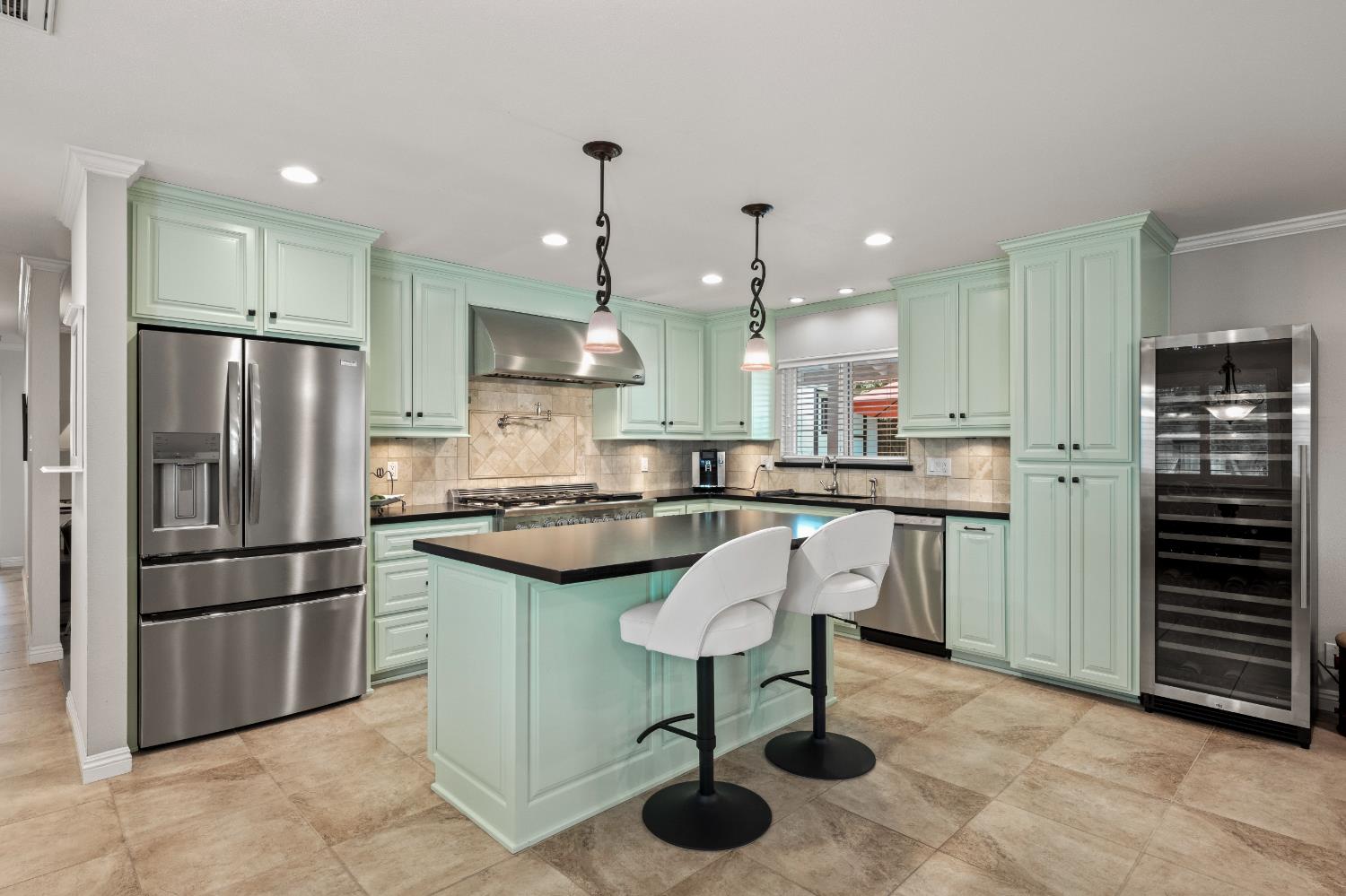 1325 Philomene Court Carmichael, CA 95608 - Photo 5 of 40 a kitchen with a refrigerator a oven and a sink