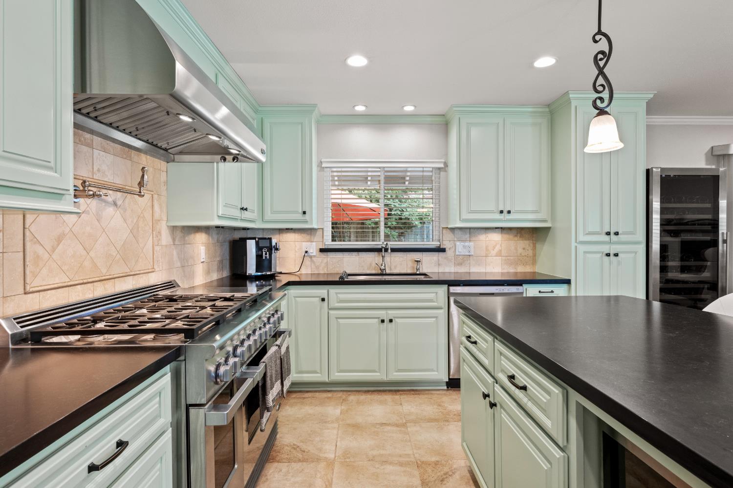 1325 Philomene Court Carmichael, CA 95608 - Photo 6 of 40 a kitchen with stainless steel appliances granite countertop a sink a stove and a refrigerator