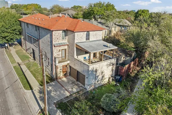 an aerial view of a house with a yard