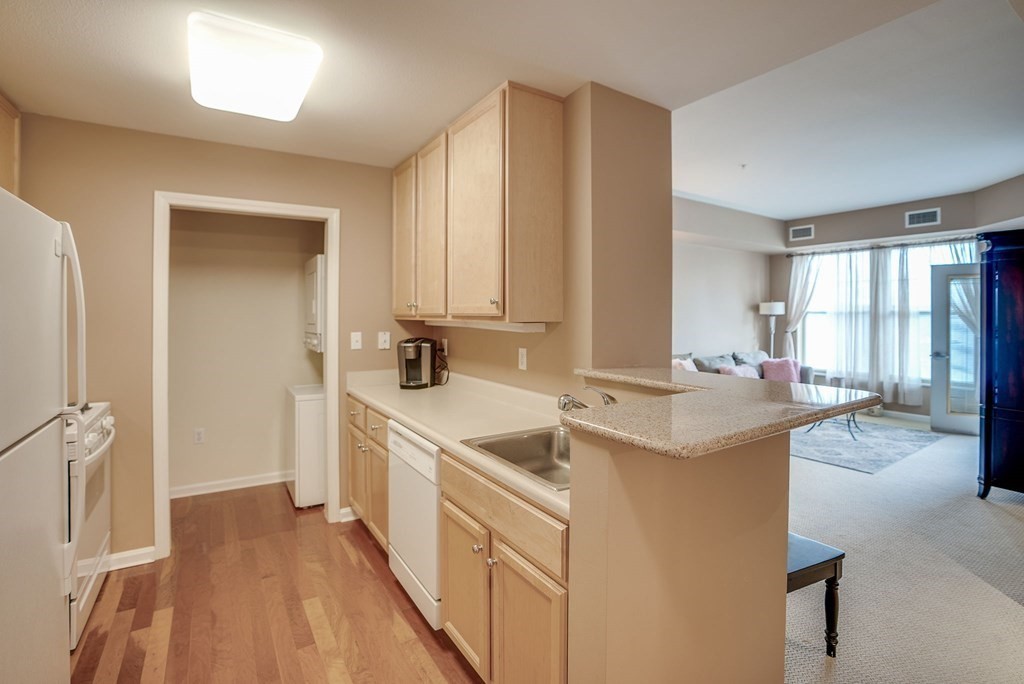 38 Village Road, Unit 508 Middleton, MA 01949 - Photo 11 of 40 a large kitchen with a sink and cabinets