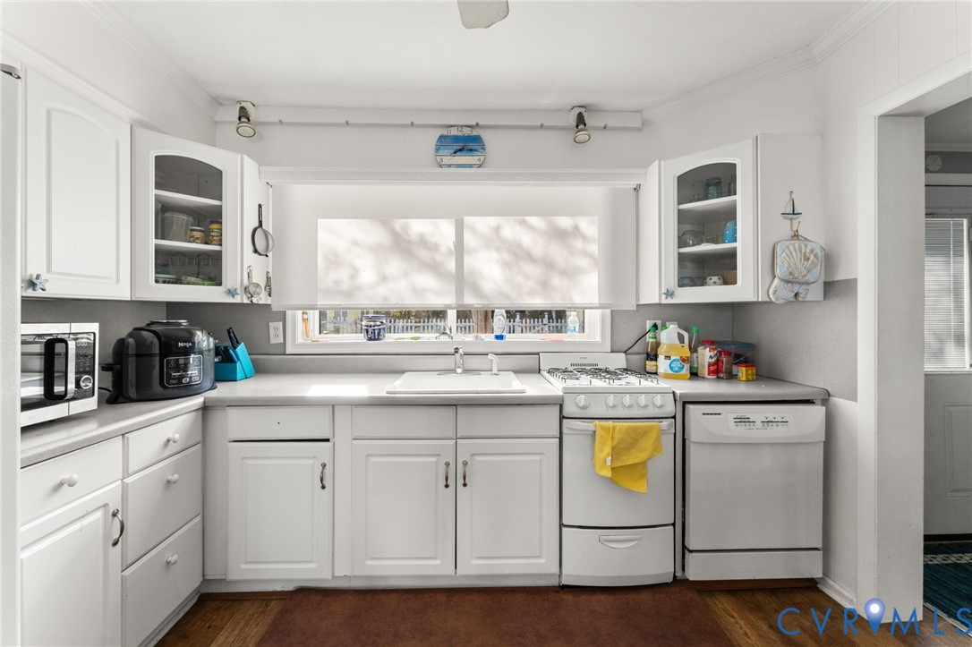 90 Deep Harbor Road Lancaster, VA 22503 - Photo 16 of 21 a kitchen with granite countertop white cabinets and white appliances