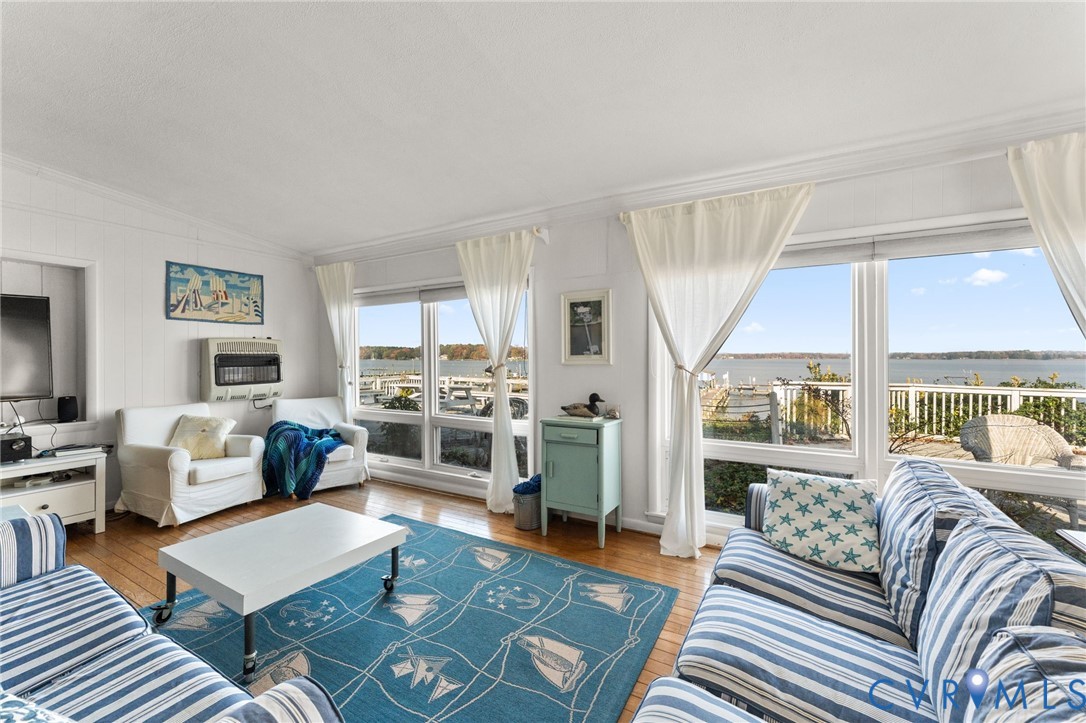 90 Deep Harbor Road Lancaster, VA 22503 - Photo 9 of 21 a living room with furniture and a large window