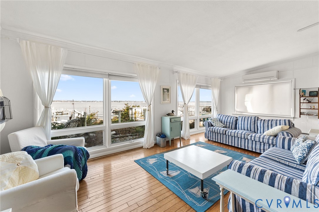 90 Deep Harbor Road Lancaster, VA 22503 - Photo 10 of 21 a living room with furniture and a wooden floor