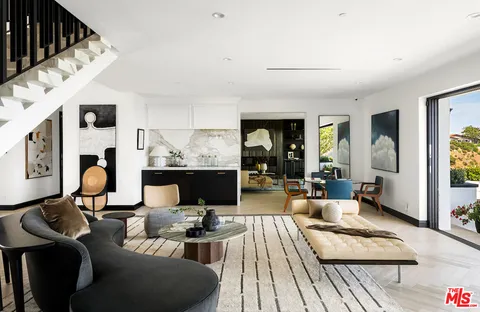 a kitchen that has a lot of cabinets in it and wooden floors