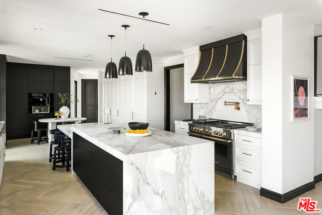 10932 Savona Road Los Angeles, CA 90077 - Photo 18 of 72 a kitchen with stainless steel appliances granite countertop a stove and a sink