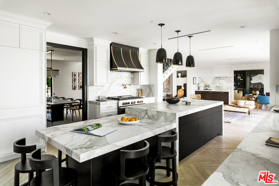 10932 Savona Road Los Angeles, CA 90077 - Photo 19 of 72 a kitchen with stainless steel appliances kitchen island granite countertop a stove a sink and a refrigerator