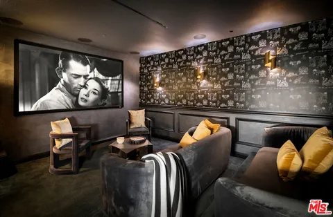 a living room with furniture and floor to ceiling window