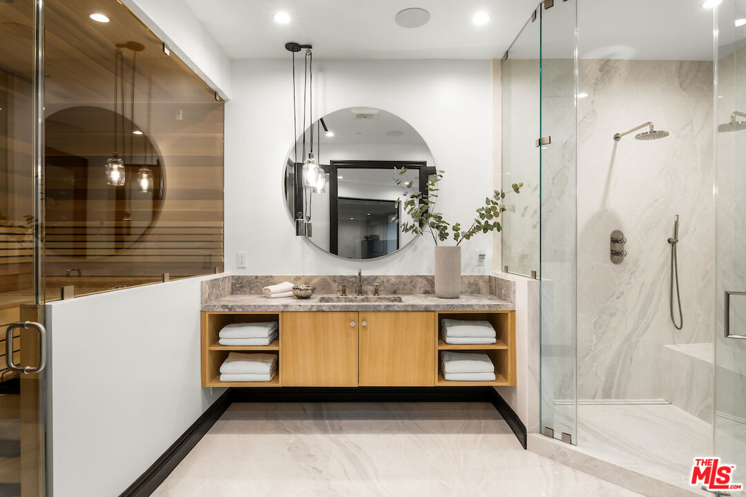 10932 Savona Road Los Angeles, CA 90077 - Photo 33 of 72 a bathroom with a double vanity sink mirror and bathtub