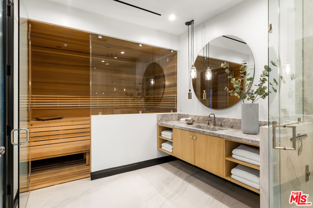 10932 Savona Road Los Angeles, CA 90077 - Photo 34 of 72 a en suite bathroom with a double vanity sink and a mirror