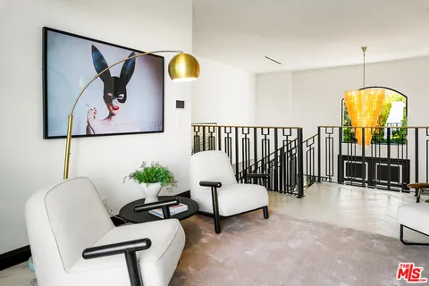 a room with furniture a rug and a window