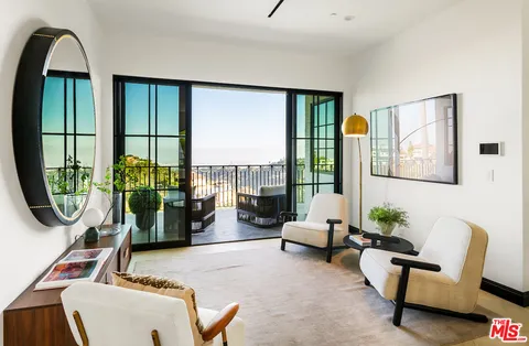 a bedroom with a large bed and a large window