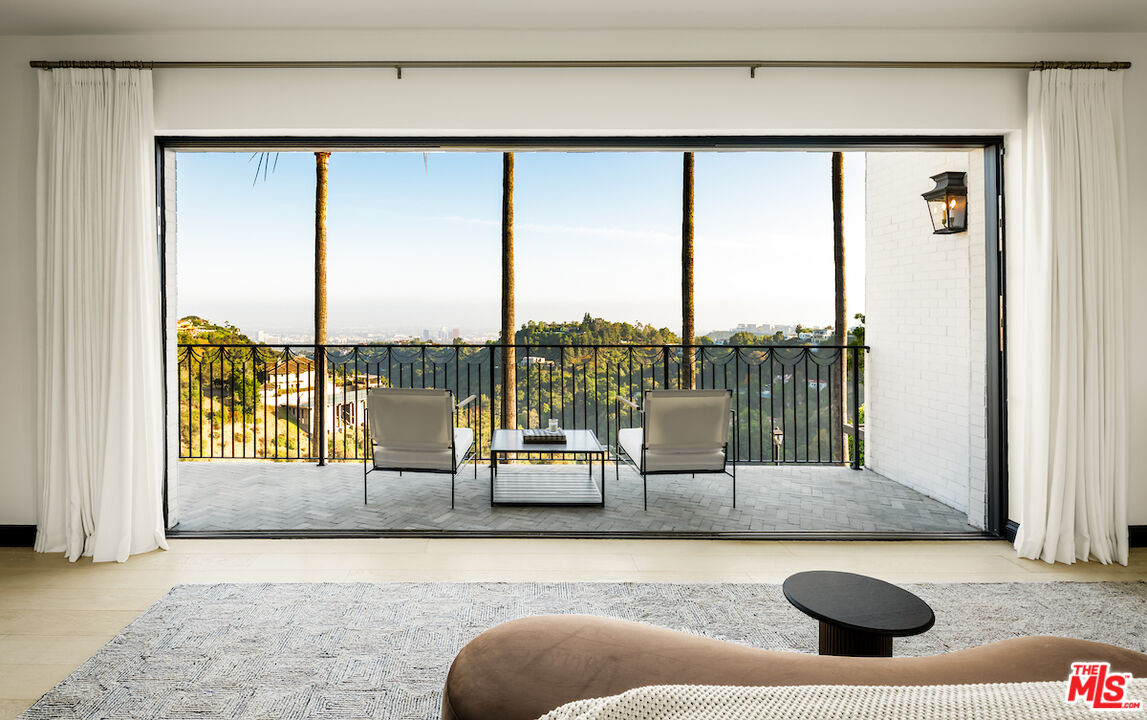 10932 Savona Road Los Angeles, CA 90077 - Photo 39 of 72 a living room with furniture and floor to ceiling window