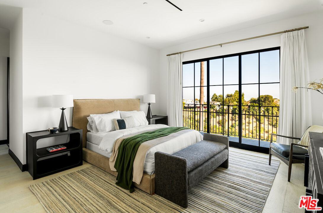 10932 Savona Road Los Angeles, CA 90077 - Photo 47 of 72 a bedroom with a bed and a large window
