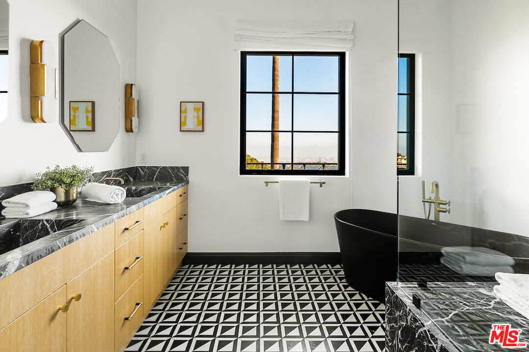 10932 Savona Road Los Angeles, CA 90077 - Photo 49 of 72 a room with furniture a rug and a window