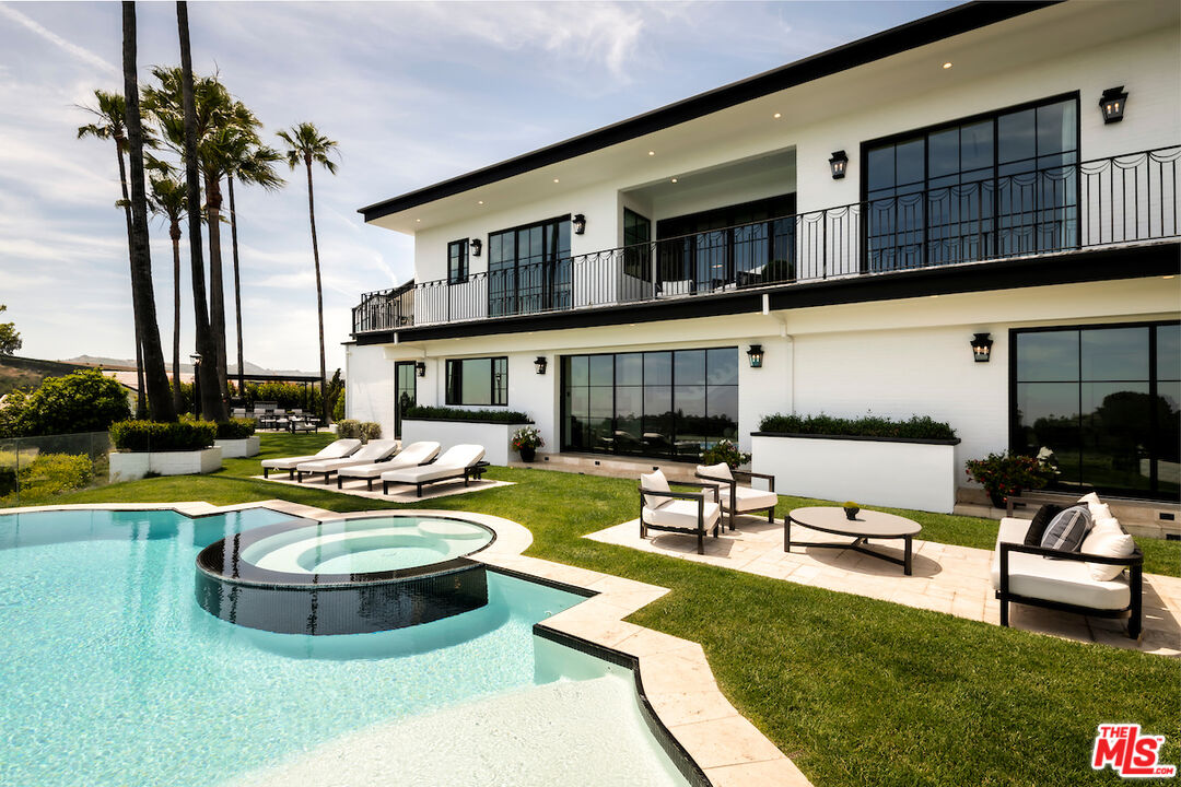 10932 Savona Road Los Angeles, CA 90077 - Photo 58 of 72 a swimming pool with outdoor seating and yard