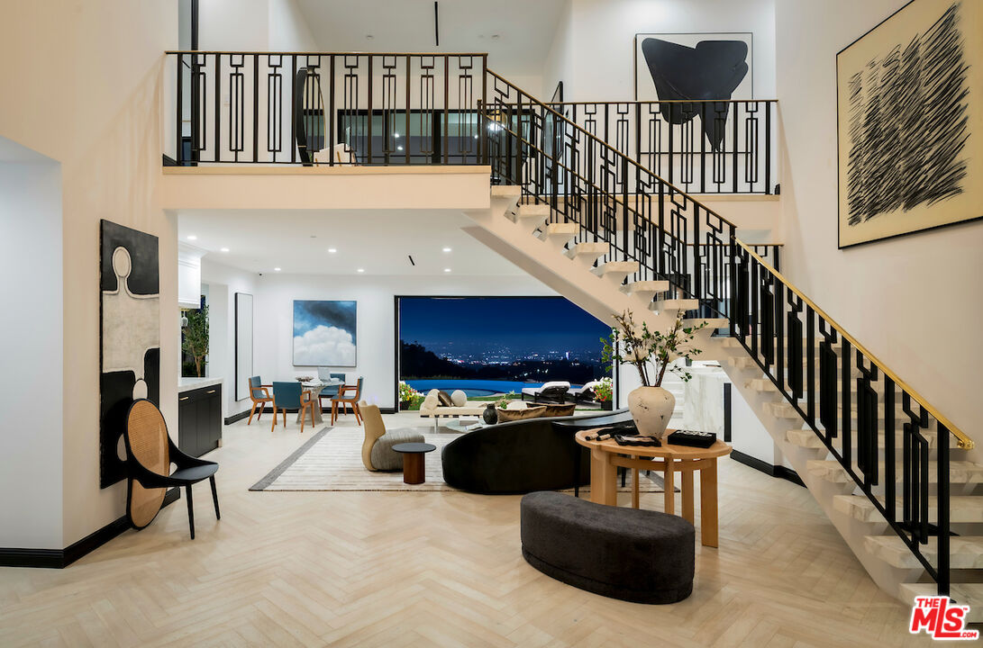 10932 Savona Road Los Angeles, CA 90077 - Photo 67 of 72 a living room with couches a flat screen tv and a table with wooden floor