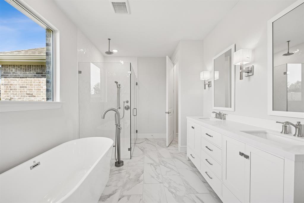 1317 Benjamin Trail Van Alstyne, TX 75495 - Photo 13 of 29 a bathroom with a tub sink double vanity granite tub shower and mirror