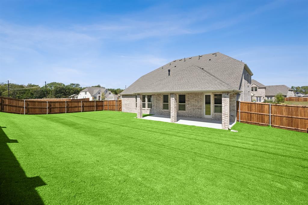 1317 Benjamin Trail Van Alstyne, TX 75495 - Photo 27 of 29 a front view of a house with a garden