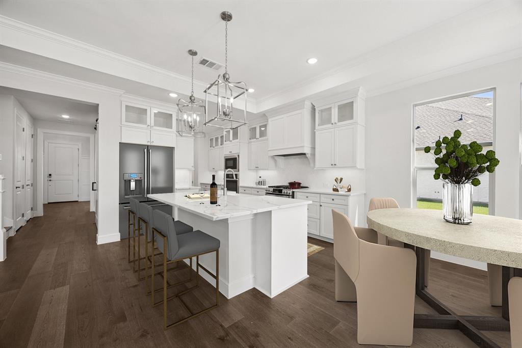 1317 Benjamin Trail Van Alstyne, TX 75495 - Photo 6 of 29 a kitchen with a dining table chairs sink and cabinets