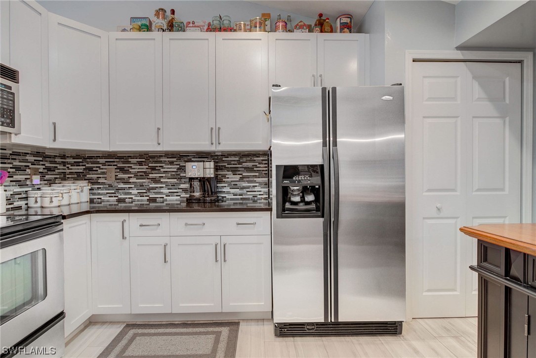 8337 Robin Road Fort Myers, FL 33967 - Photo 11 of 36 a kitchen with stainless steel appliances granite countertop a refrigerator and a sink