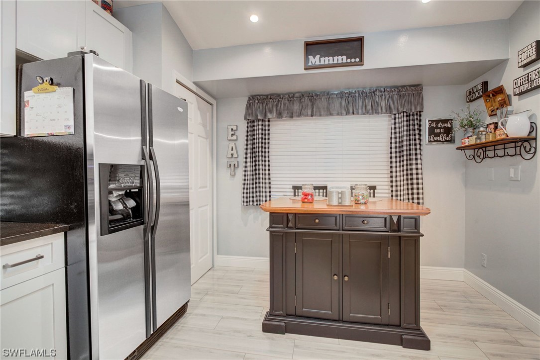 8337 Robin Road Fort Myers, FL 33967 - Photo 12 of 36 a kitchen with stainless steel appliances a refrigerator and a stove