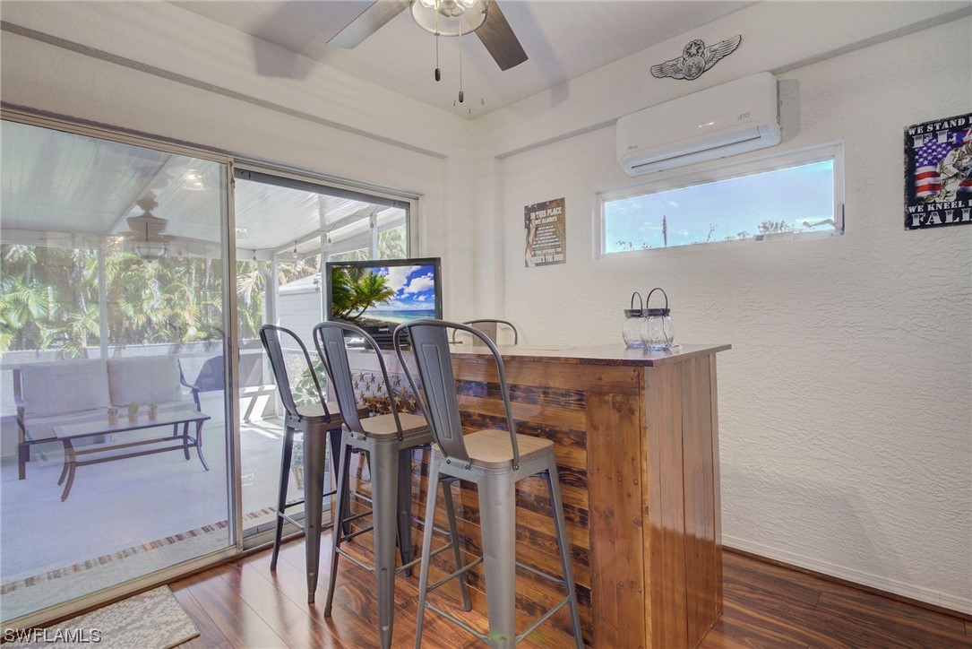 8337 Robin Road Fort Myers, FL 33967 - Photo 16 of 36 a view of a dining room with furniture window and wooden floor