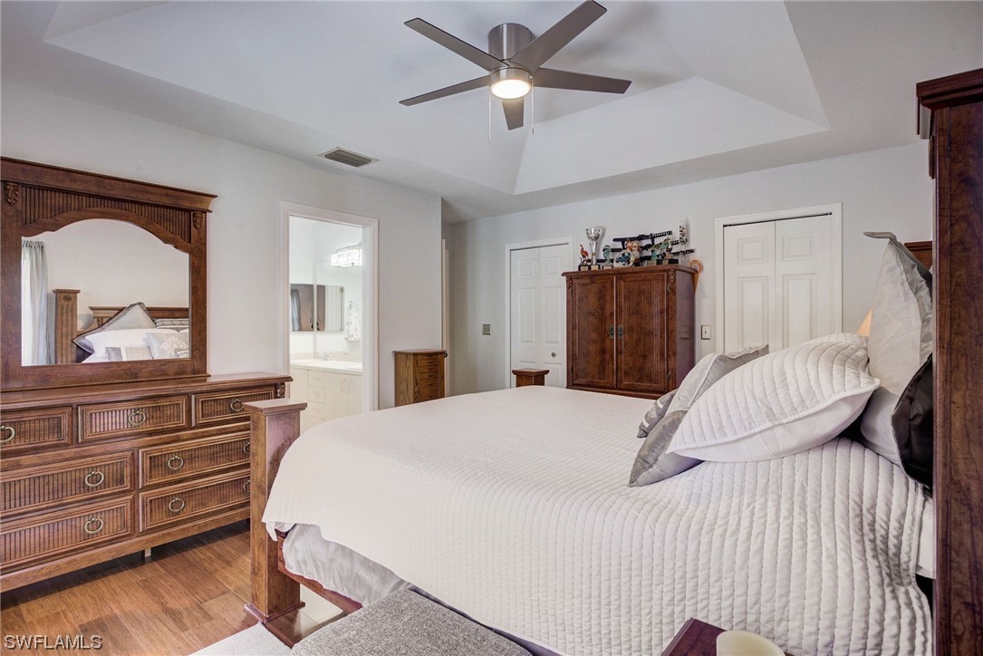 8337 Robin Road Fort Myers, FL 33967 - Photo 18 of 36 a bedroom with a bed and a large mirror with a dresser