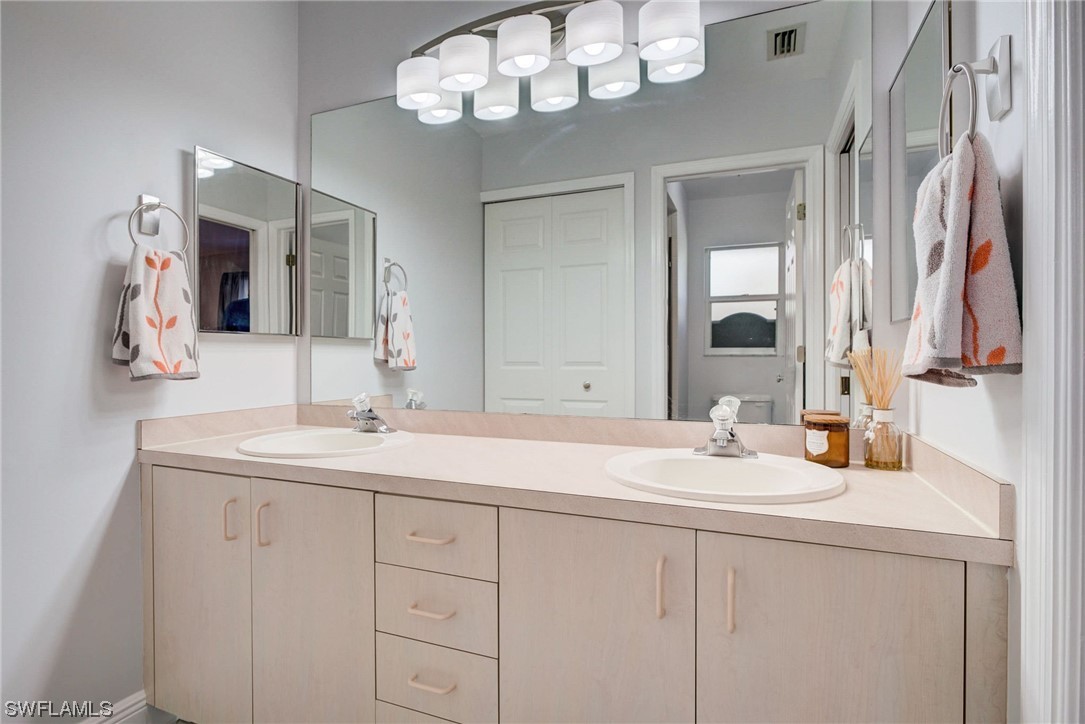 8337 Robin Road Fort Myers, FL 33967 - Photo 19 of 36 a bathroom with a sink vanity and a mirror