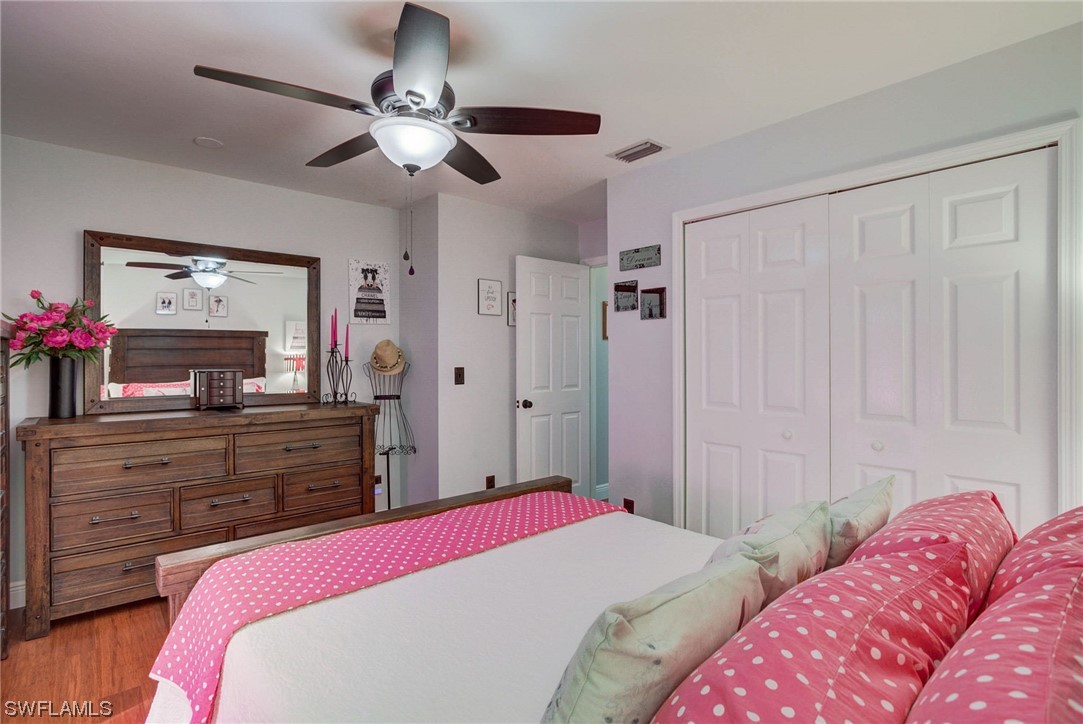 8337 Robin Road Fort Myers, FL 33967 - Photo 21 of 36 a bedroom with a bed window and a dresser in it